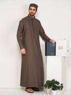 Man wearing a brown traditional outfit with a white background