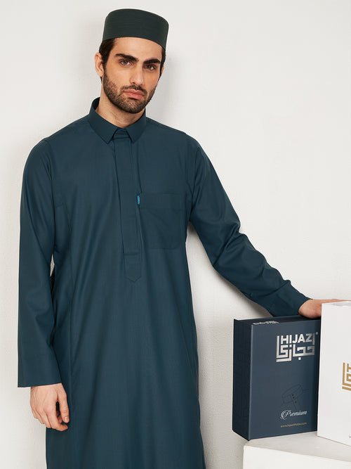 Man wearing a dark green traditional outfit with a white background