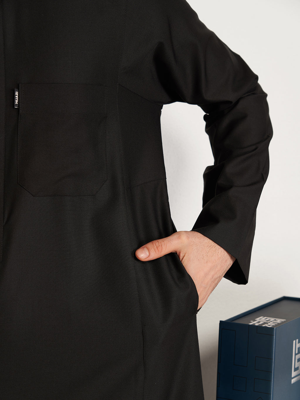 Person wearing a black outfit with a white background