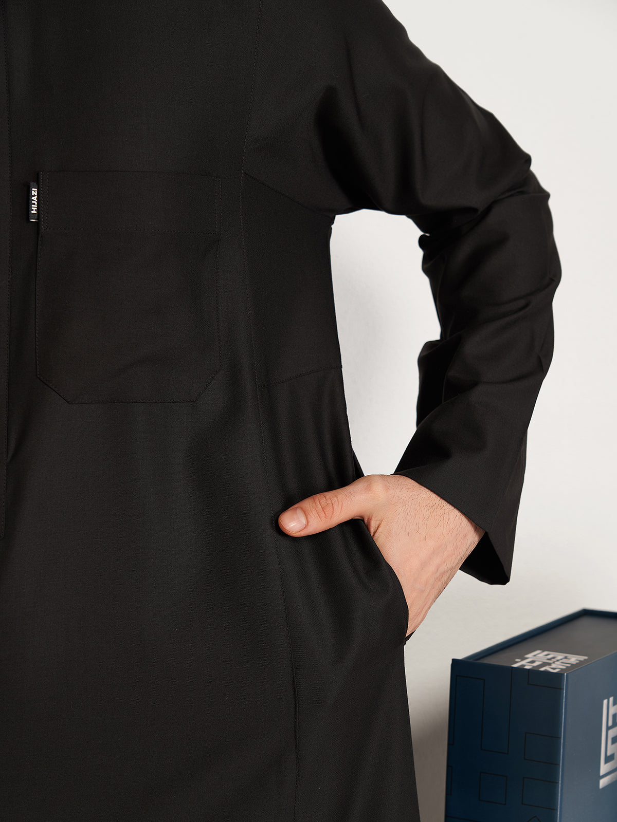 Person wearing a black outfit with a white background